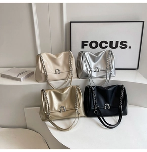 Detail view of four textured PU leather shoulder bags in white, silver, gold, and black