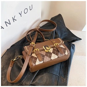 Detail of vintage crossbody bag with brown leather, argyle fabric and gold clasp