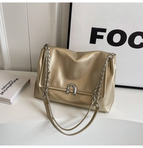 Detail of champagne gold PU leather shoulder bag with silver chain strap and U-shaped clasp