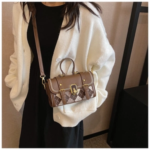 Detail of vintage brown plaid crossbody bag with metal twist lock and leather strap