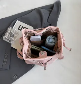 Top view of pink bucket bag interior showing spacious storage for phone and umbrella