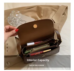 Internal capacity of brown crocodile pattern shoulder bag with multiple compartments