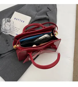 Detail view of red bridal handbag interior showing spacious compartments and zip pocket