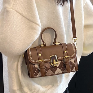 Vintage brown patchwork crossbody bag with metallic clasp and adjustable shoulder strap