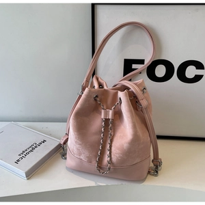 Detail of pink bucket bag with chain drawstring and premium suede texture finish