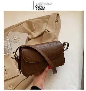 Detail showing high-quality crocodile pattern leather on a coffee brown shoulder bag
