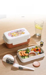 Detail of double-layer cartoon lunch box showing inner compartments and cutlery storage