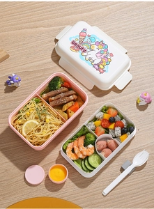 Detail of pink double-layer lunch box with unicorn pattern and divided compartments