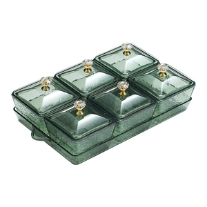 Green emerald glass snack tray with six compartments and gold-accented lids on tray