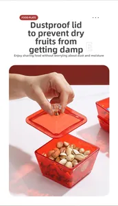 Detail of red transparent snack box with gold pattern and crystal handle for nuts