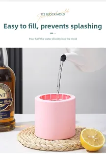 Detail of pink silicone ice ball mold being filled with water for whiskey cocktails