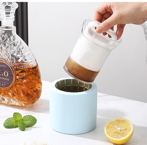 Lifting inner cup of silicone ice bucket showing hollow cylindrical ice making process