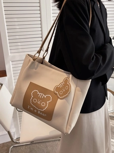 Minimalist beige tote bag with bear graphic and charms, stylish large capacity shoulder bag