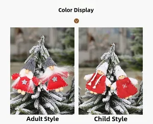 Close-up of Christmas doll ornaments with knitted hats and stars on pine branches