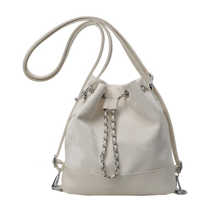 Elegant cream drawstring bucket bag with silver chain and adjustable shoulder strap