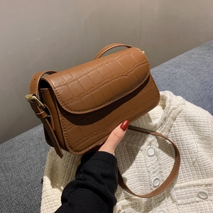 Caramel brown crocodile embossed leather shoulder bag with gold hardware and flap closure