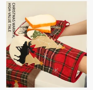 Close-up of heat-resistant Christmas baking glove with plaid pattern and elk appliqué