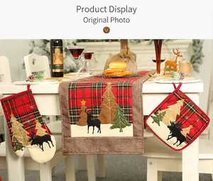 Plaid Christmas kitchen set with table runner, oven mitt, and pot holder on a table