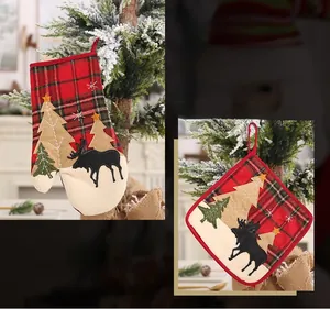 Detail view of red plaid Christmas stocking and heat-resistant mat with reindeer motif