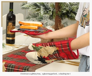 Close-up of Christmas oven mitt with reindeer patch and matching plaid table runner