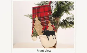 Close-up of Christmas plaid glove decoration with reindeer and tree on a holiday tree