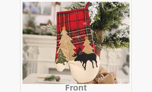 Close-up of Christmas plaid glove decoration with reindeer and tree on a holiday tree