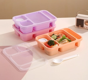 Divided lunch box with utensils showing macro meal prep of shrimp, sandwich, and salad