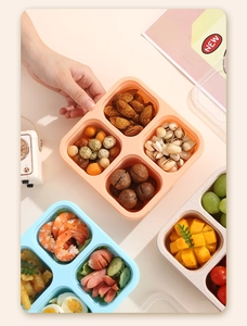 Close-up of portable 4-compartment lunch box showing organized snacks and fresh food