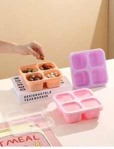 Detail view of a 4-compartment bento box for snacks in warm pastel silicone colors