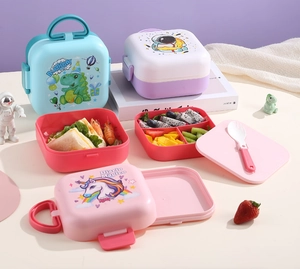 Detail view of portable bento box showing internal compartments with fresh snacks and cutlery