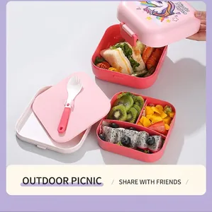Close-up of pink double-layer unicorn bento box with divided sections for picnic use