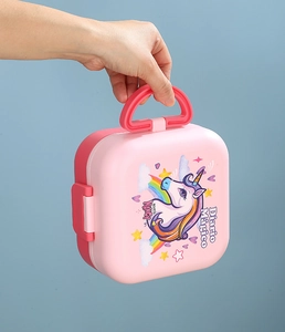 Pink double-layer lunch box with unicorn pattern and handle held by person