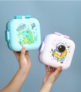 Detail of cute cartoon lunch boxes with space and dinosaur prints for students