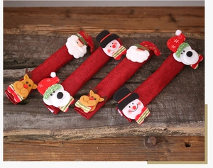 Close-up of four Christmas burlap handle covers with 3D Santa, Snowman, and Reindeer motifs