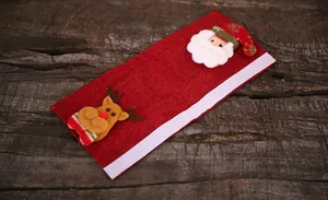 Front detail of red linen Christmas appliance handle cover with Santa and reindeer applique