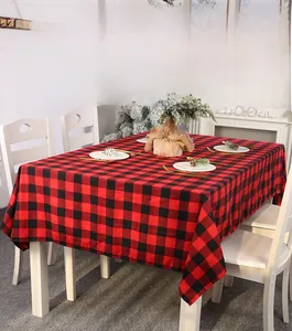Close-up of red and black buffalo plaid Christmas tablecloth in a cozy dining setting
