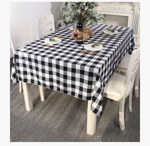 Detailed view of black and white gingham tablecloth in a festive Christmas table setting