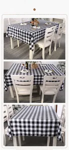 Detailed view of black and white plaid tablecloth with elegant drape on rectangular table