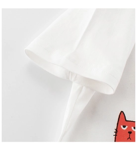 Close-up of sleeve stitching and red cartoon cat print on a white kids' cotton T-shirt