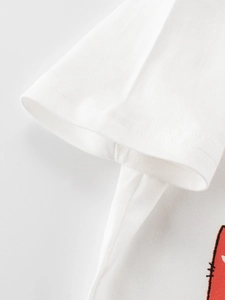 Detailed macro view of high-quality stitching on kids' white cotton short sleeve T-shirt