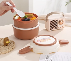 Detail of round double-layer bento box with cute bear pattern and side spoon