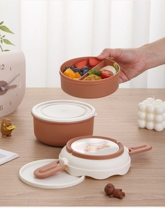 Detail of round stackable bento box with divided layers for fruits and meal prep