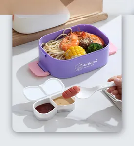 Detail of purple bento box showing dip container and spoon with noodles and shrimp
