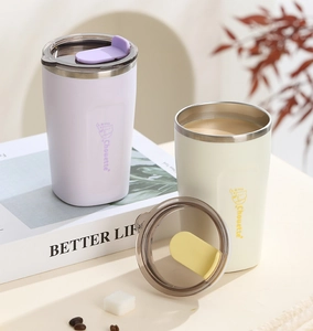 Close-up of matte stainless steel insulated coffee mugs with cartoon illustrations