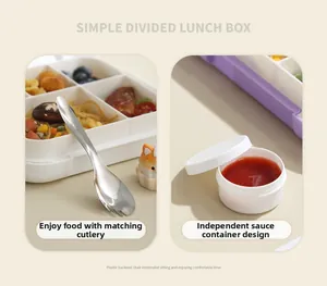 Detail view of a 4-compartment lunch box with stainless steel utensil and sauce cup