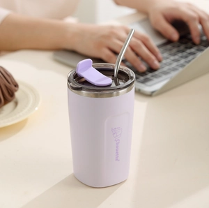 Close-up of lavender stainless steel coffee mug with Chouette logo and metal straw