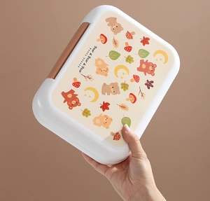 Close-up of the rectangular plastic lunch box featuring cute bear prints and side buckles