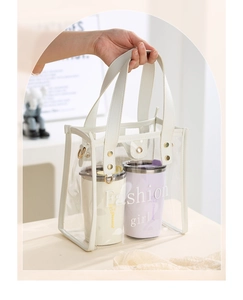 Transparent PVC tote bag featuring white handles holding two stylish insulated coffee mugs