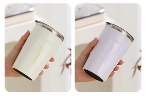 Detail of insulated stainless steel coffee cups with cat logo and anti-slip rubber base