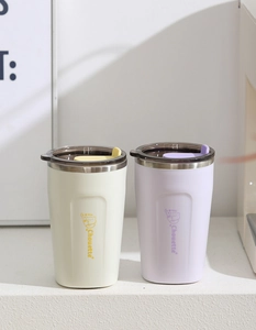 Close-up of matte stainless steel mugs with cute cat prints and leak-proof lids